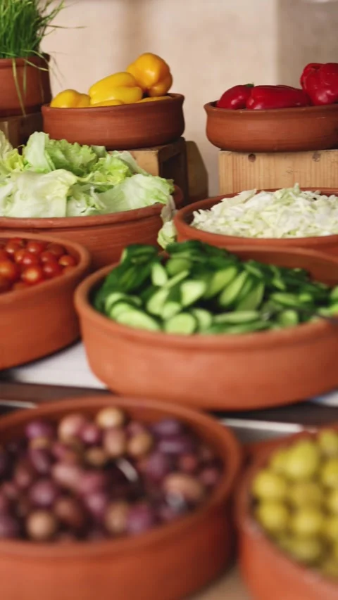Delicious buffet table with Fresh and Vibrant Organic Vegetables in Rustic Clay Stock Footage 306055472