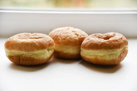 Delicious buns with jam on a white background. Sweet doughnuts with stuffin.. Stock Photos