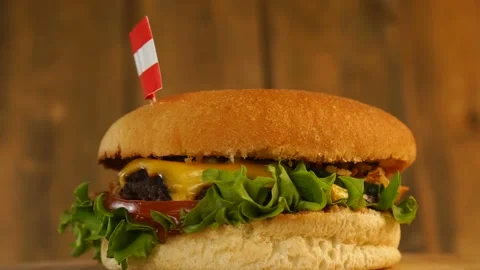 Delicious burger with small Austrian flag on top of them with toothpicks. Yummy Stock Footage 145177355