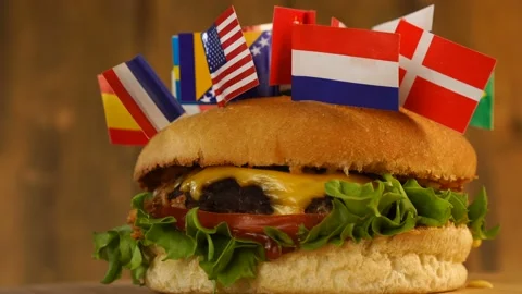 Delicious burger with small flag different countries on top of them with Stock Footage 145389169