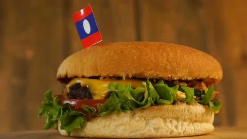 Delicious burger with small flag of Laos on top of them with toothpicks. Yummy Stock Footage 145388480