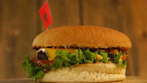 Delicious burger with small Moroccan flag on top of them with toothpicks. Yummy Stock Footage 145388910