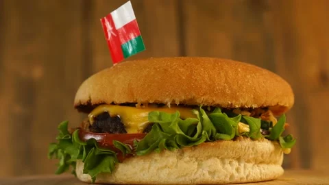 Delicious burger with small Omani flag on top of them with toothpicks. Yummy Stock Footage 145354898