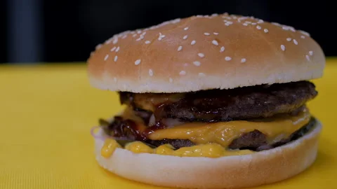 Delicious burger on the yellow table. Stock Footage 145988346