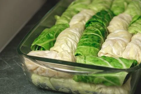Delicious cabbage rolls ready for baking in a cozy kitchen setting 库存照片
