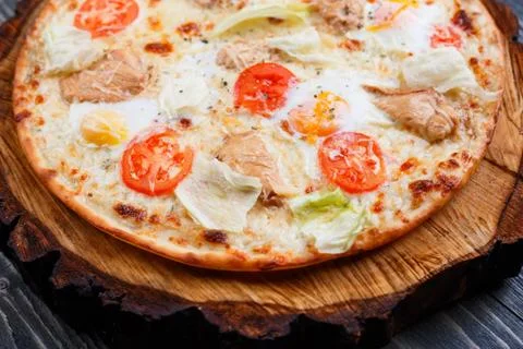Delicious caesar pizza with cherry tomatoes, grilled chicken, le Stock Photos