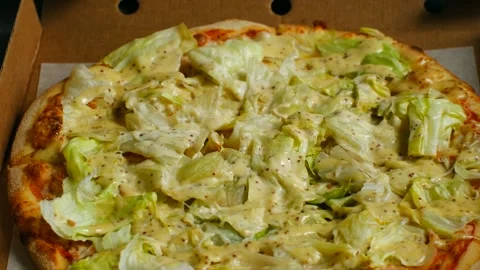 Delicious caesar salad pizza with crunchy lettuce and creamy dressing Stock Footage 313643486
