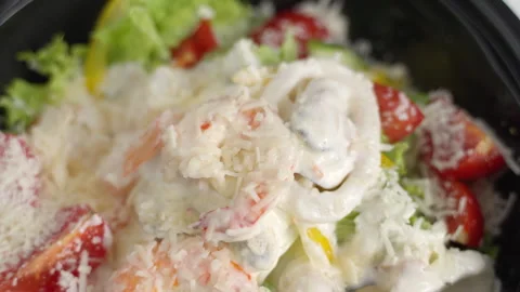 Delicious caesar salad with shrimp and calamari sprinkled with parmesan cheese Stock Footage 335947191