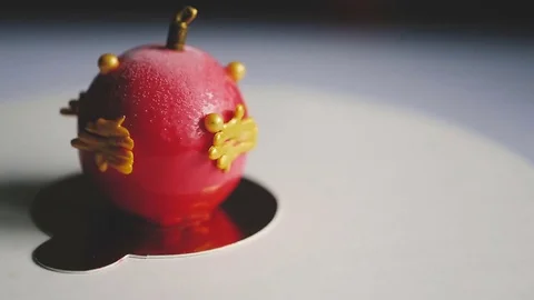 Delicious cake with red mirror glaze and chocolate Christmas ornament turns on a 库存影片 83541199