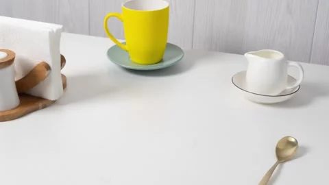 Delicious cake served with tea in bright mugs on a simple table setting Stock Footage 319964643