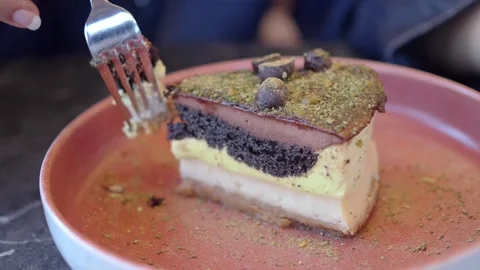 Delicious cake slice served on a plate with a fork ready to take a bite Stock Footage 346964172
