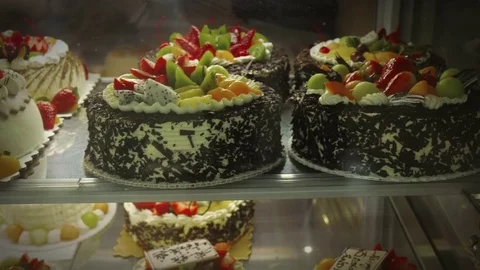 Delicious cakes behind window Video stock 73938478