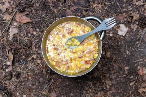 Delicious Camp Breakfast: Scrambled Eggs with Bacon, Top View Stock Photos