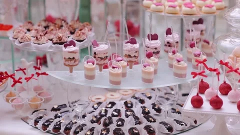 Delicious candy bar dessert table inside of the celebration hall. Lots of sweets Stock Footage 132697447