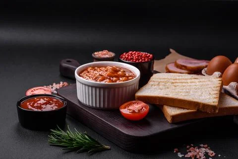 Delicious canned beans in a tomato in a white ceramic bowl Stock Photos
