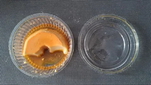 Delicious caramel custard pudding served in a small clear container Stock Photos