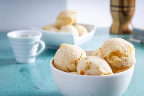 Delicious cheese bread, typical Brazilian dish, on a table with a green bac.. Stock Photos
