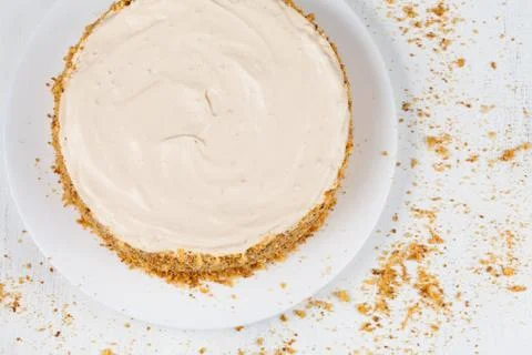 Delicious cheese cake with walnut and raisins on white background Stock Photos