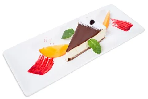 Delicious cheesecake with mango and red jam. Stock Photos