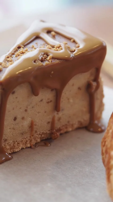 Delicious Cheesecake Slice Topped with Dripping Caramel Sauce Stock Footage 333723008