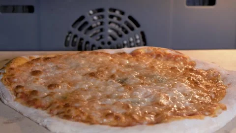 Delicious cheesy pizza baking inside an oven Video stock 333331267