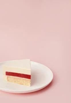 Delicious cherry mousse cake slice with the layers and texture displayed on Stock Photos
