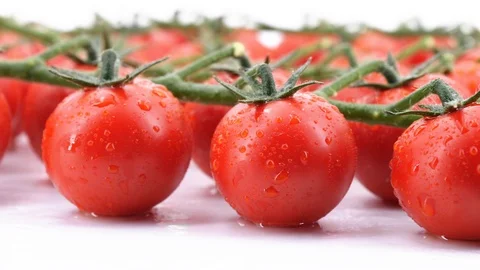Delicious cherry tomatoes rotating, (loopable) on white background. Stock Footage 113625960