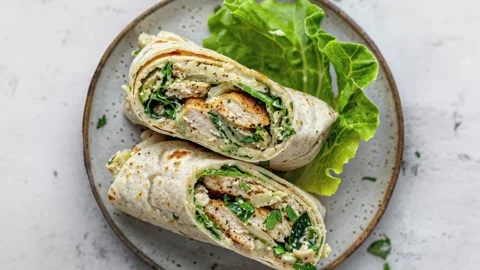 Delicious Chicken Caesar Wrap with Fresh Lettuce on Plate Stock Footage 281434329