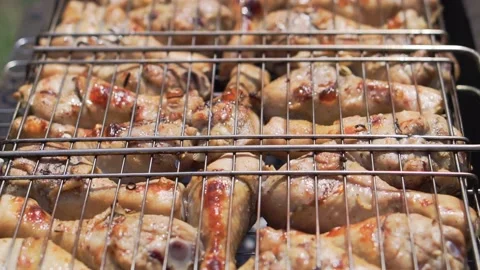 Delicious chicken on grill, barbeque, close up, slow motion. Stock Footage 130905367