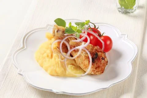 Delicious chicken with mashed potatoes and tomatoes Stock Photos