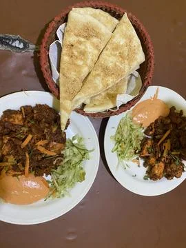 Delicious chicken platter with flatbread, fresh salad Stock Photos