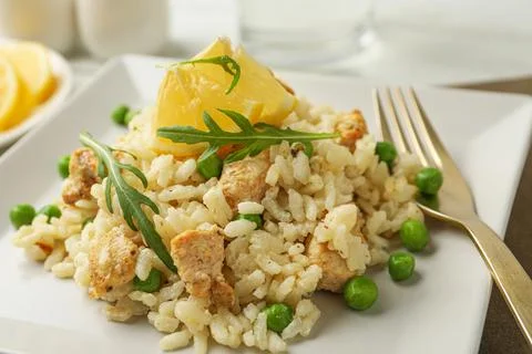 Delicious chicken risotto with lemon on table, closeup 写真素材