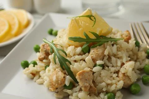 Delicious chicken risotto with lemon on table, closeup 写真素材