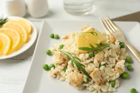 Delicious chicken risotto with lemon on table, closeup 写真素材