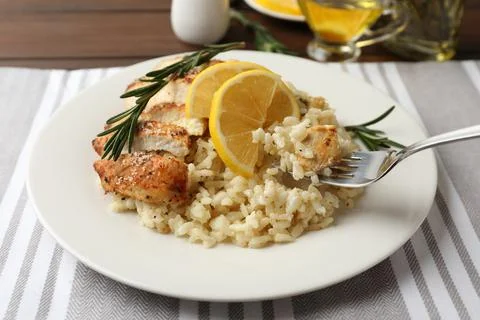 Delicious chicken risotto with lemon on table, closeup 写真素材