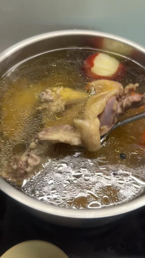 Delicious chicken soup boiling in a pot Stock Footage 340237679
