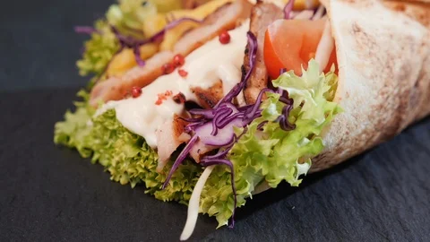 Delicious chicken wrap with appetizing ingredients showing Video stock 105721765