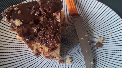 Delicious chocolate cake slice on patterned plate motion video footage Stock Footage 339248254