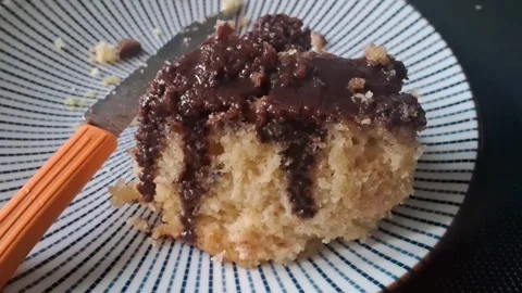 Delicious chocolate cake slice on patterned plate motion video footage Stock Footage 339248263