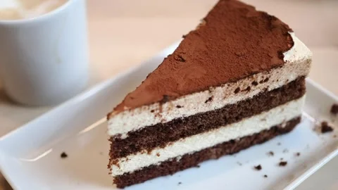 Delicious chocolate cake slice on a plate Stock Footage 336227706