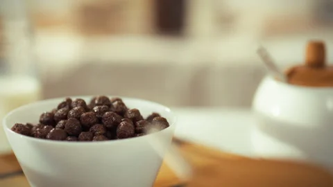 Delicious chocolate cereal ready to be enjoyed in a cozy kitchen setting for Stock Footage 323764600