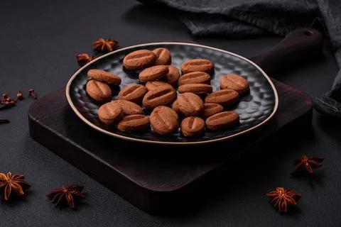 Delicious chocolate cookies with nuts on a black ceramic plate on a dark conc Stock Photos