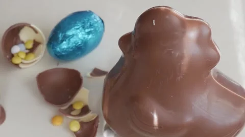 Delicious Chocolate Easter Bunny with Colorful Candy Eggs on White Surface Stock Footage 332944358