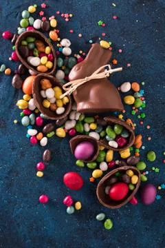 Delicious chocolate easter eggs ,bunny and sweets on dark blue background Stock Photos