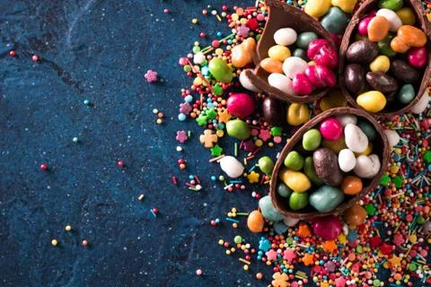 Delicious chocolate easter eggs ,bunny and sweets on dark blue background Stock Photos