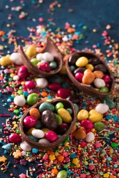 Delicious chocolate easter eggs ,bunny and sweets on dark blue background Stock Photos