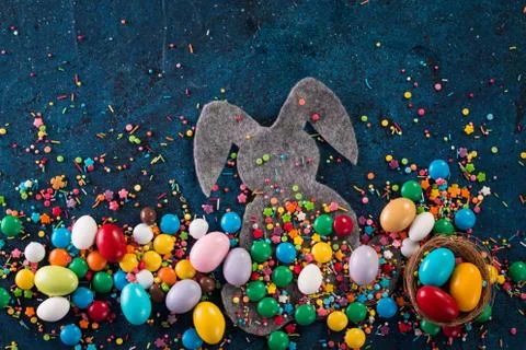 Delicious chocolate easter eggs ,bunny and sweets on dark blue background Stock Photos