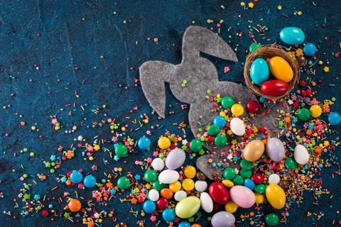 Delicious chocolate easter eggs ,bunny and sweets on dark blue background Stock Photos