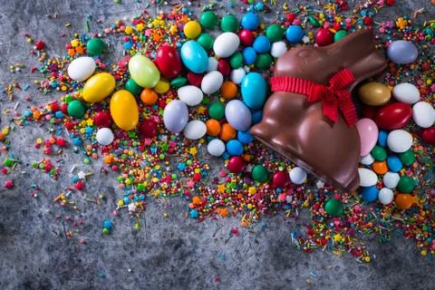 Delicious chocolate easter eggs ,bunny and sweets on dark gray background Stock Photos