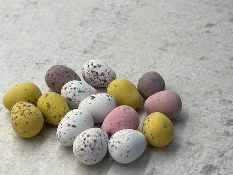 Delicious chocolate easter eggs candies on the table Stock Photos